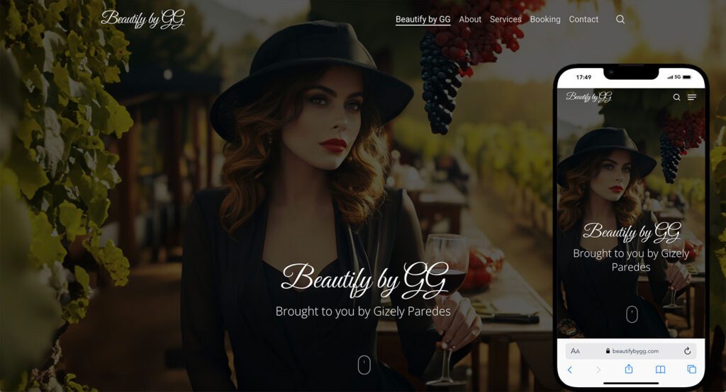 Woman with wavy blonde hair wearing a black wide-brimmed hat and black outfit, seated at a vineyard table with a glass of red wine, representing a Lash & Brow Girl Academy graduate who now owns her own beauty studio
